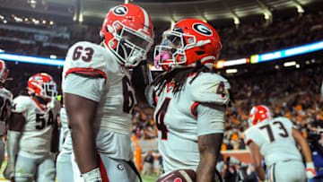 Nov 13, 2021; Knoxville, Tennessee, USA; Georgia Bulldogs running back James Cook (4) and offensive lineman Sedrick Van Pran (63) celebrate during the fourth quarter against the Tennessee Volunteers at Neyland Stadium. Mandatory Credit: Bryan Lynn-USA TODAY Sports