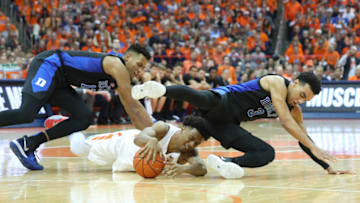 SYRACUSE, NY - FEBRUARY 23: (L-R) Javin DeLaurier #12 of the Duke Blue Devils, Elijah Hughes #33 of the Syracuse Orange and Tre Jones #3 of the Duke Blue Devils battle for the ball during the second half at the Carrier Dome on February 23, 2019 in Syracuse, New York. Duke defeated Syracuse 75-65. (Photo by Rich Barnes/Getty Images)