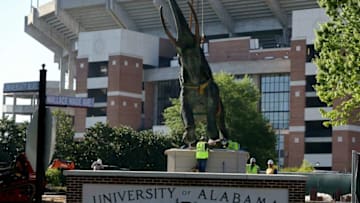 A crew from McAbee Construction uses a crane to lift and set the Tuska statue at its new home outside Bryant-Denny Stadium Monday, April 12, 2021. [Staff Photo/Gary Cosby Jr.]Tuska Moves To Bryant Denny Stadium