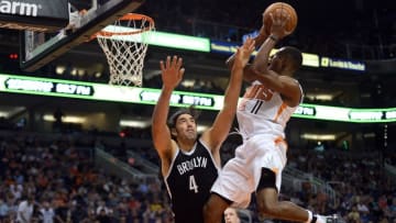Nov 12, 2016; Phoenix, AZ, USA; Phoenix Suns guard Brandon Knight (11) attempts a shot over Brooklyn Nets forward Luis Scola (4) during the first half at Talking Stick Resort Arena. Mandatory Credit: Joe Camporeale-USA TODAY Sports