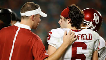 Dec 31, 2015; Miami Gardens, FL, USA; Oklahoma Sooners quarterback Baker Mayfield (6) talks with offensive coordinator and quarterback coach Lincoln Riley in the third quarter of the 2015 CFP Semifinal against the Clemson Tigers at the Orange Bowl at Sun Life Stadium. Mandatory Credit: Kim Klement-USA TODAY Sports