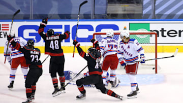 TORONTO, ONTARIO - AUGUST 03: Jordan Martinook #48 of the Carolina Hurricanes celebrates with Brock McGinn #23 and Morgan Geekie #43 after scoring a goal against the New York Rangers in the second quarter of Game Two of the Eastern Conference Qualification Round prior to the 2020 NHL Stanley Cup Playoffs at Scotiabank Arena on August 3, 2020 in Toronto, Ontario, Canada. (Photo by Andre Ringuette/Freestyle Photo/Getty Images)
