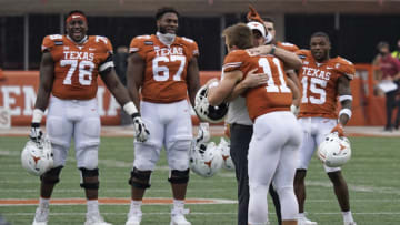 Texas Longhorns quarterback Sam Ehlinger (11) hugs head coach Tom Herman before his last home game at Darrell K Royal-Texas Memorial Stadium against the Iowa State Cyclones . Mandatory Credit: Scott Wachter-USA TODAY Sports
