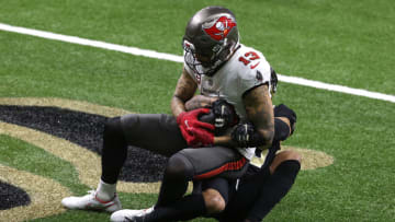 NEW ORLEANS, LOUISIANA - JANUARY 17: Mike Evans #13 of the Tampa Bay Buccaneers scores a 3 yard touchdown against Marshon Lattimore #23 the New Orleans Saints during the second quarter in the NFC Divisional Playoff game at Mercedes Benz Superdome on January 17, 2021 in New Orleans, Louisiana. (Photo by Chris Graythen/Getty Images)