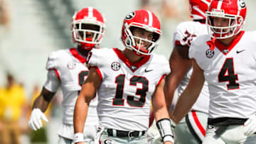 Sep 17, 2022; Columbia, South Carolina, USA; Georgia Bulldogs quarterback Stetson Bennett (13) and Georgia Bulldogs tight end Oscar Delp (4) celebrate a touchdown run by Bennett against the South Carolina Gamecocks in the second half at Williams-Brice Stadium. Mandatory Credit: Jeff Blake-USA TODAY Sports