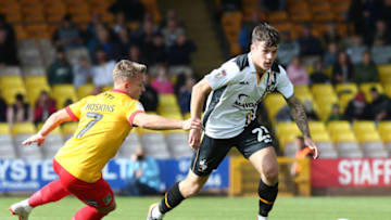 BURSLEM, ENGLAND - SEPTEMBER 15: Mitchell Clark of Port Vale moves forward with the ball away from Sam Hoskins of Northampton Town during the Sky Bet League Two match between Port Vale and Northampton Town at Vale Park on September 15, 2018 in Burslem, United Kingdom. (Photo by Pete Norton/Getty Images)