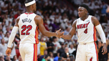 Jimmy Butler #22 and Victor Oladipo #4 of the Miami Heat high five against the Philadelphia 76ers(Photo by Michael Reaves/Getty Images)