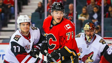 Oct 5, 2016; Calgary, Alberta, CAN; Calgary Flames left wing Micheal Ferland (79) and Arizona Coyotes defenseman Anthony DeAngelo (77) fight for position in front of Arizona Coyotes goalie Mike Smith (41) during the first period during a preseason hockey game at Scotiabank Saddledome. Mandatory Credit: Sergei Belski-USA TODAY Sports