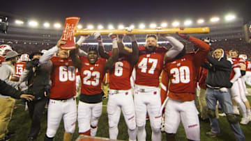 Nov 26, 2016; Madison, WI, USA; The Wisconsin Badgers celebrate with the Paul Bunyan Football Trophy following the game against the Minnesota Golden Gophers at Camp Randall Stadium. Wisconsin won 31-17. Mandatory Credit: Jeff Hanisch-USA TODAY Sports