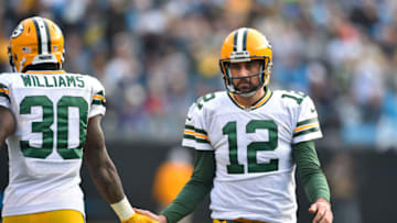 Dec 17, 2017; Charlotte, NC, USA; Green Bay Packers quarterback Aaron Rodgers (12) slaps hands with running back Jamaal Williams (30) in the second quarter at Bank of America Stadium. Mandatory Credit: Bob Donnan-USA TODAY Sports