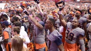 Oct 15, 2016; Syracuse, NY, USA; Syracuse Orange players celebrate a victory over the Virginia Tech Hokies at the Carrier Dome. Syracuse won 31-17. Mandatory Credit: Mark Konezny-USA TODAY Sports