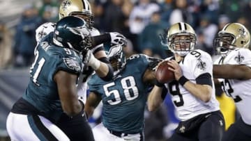 Jan 4, 2014; Philadelphia, PA, USA; New Orleans Saints quarterback Drew Brees (9) prepares to throw the ball as Philadelphia Eagles outside linebacker Trent Cole (58) and Eagles defensive end Fletcher Cox (91) chase in the first quarter during the 2013 NFC wild card playoff football game at Lincoln Financial Field. Mandatory Credit: Geoff Burke-USA TODAY Sports