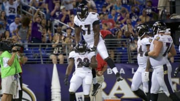Aug 11, 2016; Baltimore, MD, USA; Baltimore Ravens offensive tackle Stephane Nembot (67) and defensive back Sam Brown (28) celebrate a touchdown against the Carolina Panthers at M&T Bank Stadium. Mandatory Credit: Rafael Suanes-USA TODAY Sports