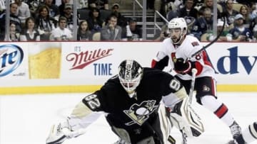 May 14, 2013; Pittsburgh, PA, USA; Pittsburgh Penguins goalie Tomas Vokoun (92) dives to make a save as Ottawa Senators left wing Cory Conacher (89) looks for a rebound during the first period in game one of the second round of the 2013 Stanley Cup Playoffs at the CONSOL Energy Center. Mandatory Credit: Charles LeClaire-USA TODAY Sports