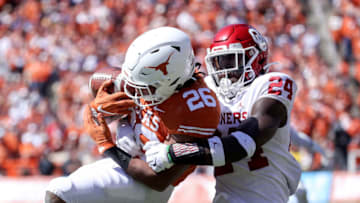 Oct 12, 2019; Dallas, TX, USA; Oklahoma Sooners linebacker Brian Asamoah (24) tackles Texas Longhorns running back Keaontay Ingram (26) during the game at the Cotton Bowl. Mandatory Credit: Kevin Jairaj-USA TODAY Sports