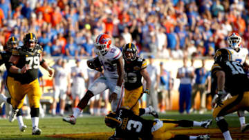 TAMPA, FL - JANUARY 2: Linebacker Daniel McMillian #13 of the Florida Gators attepts to evade a tackle by wide receiver Jay Scheel #3 of the Iowa Hawkeyes after intercepting a pass by quarterback C.J. Beathard during the fourth quarter of the Outback Bowl NCAA college football game on January 2, 2017 at Raymond James Stadium in Tampa, Florida. (Photo by Brian Blanco/Getty Images)