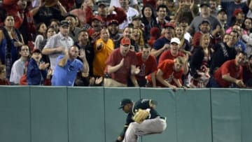 Jun 10, 2014; Anaheim, CA, USA; Oakland Athletics left fielder Yoenis Cespedes (52) fields the ball during the eighth inning against the Los Angeles Angels at Angel Stadium of Anaheim. Mandatory Credit: Richard Mackson-USA TODAY Sports