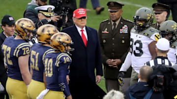 PHILADELPHIA, PENNSYLVANIA - DECEMBER 14: U.S. President Donald Trump participates in the coin toss before the game between the Army Black Knights and the Navy Midshipmen. (Photo by Elsa/Getty Images)