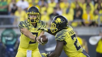 Sep 10, 2016; Eugene, OR, USA; Oregon Ducks quarterback Dakota Prukop (9) hands off to running back Royce Freeman (21) against the Virginia Cavaliers during the second quarter at Autzen Stadium. Mandatory Credit: Cole Elsasser-USA TODAY Sports