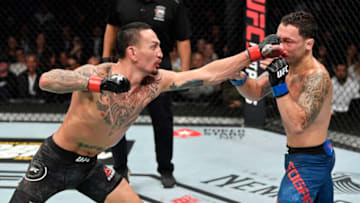 EDMONTON, ALBERTA - JULY 27: (L-R) Max Holloway punches Frankie Edgar in their UFC featherweight championship bout during the UFC 240 event at Rogers Place on July 27, 2019 in Edmonton, Alberta, Canada. (Photo by Jeff Bottari/Zuffa LLC/Zuffa LLC)