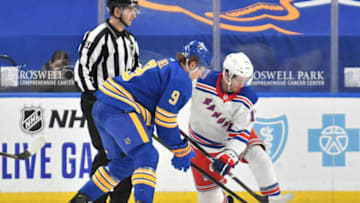 Jan 28, 2021; Buffalo, New York, USA; Buffalo Sabres center Jack Eichel (9) and New York Rangers center Kevin Rooney (17) compete for the puck in the third period at KeyBank Center. Mandatory Credit: Mark Konezny-USA TODAY Sports