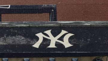 Aug 17, 2020; Bronx, New York, USA; A general view of rain falling on the New York Yankees logo on the first base dugout roof during a rain delay in the game between the New York Yankees and the Boston Red Sox. Mandatory Credit: Vincent Carchietta-USA TODAY Sports