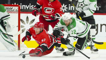 Jan 31, 2021; Raleigh, North Carolina, USA; Carolina Hurricanes center Morgan Geekie (67) and Dallas Stars center Radek Faksa (12) dive after the puck at PNC Arena. Mandatory Credit: James Guillory-USA TODAY Sports