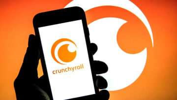 SPAIN - 2022/02/17: In this photo illustration a Crunchyroll Inc. logo seen displayed on a smartphone with a Crunchyroll Inc. logo in the background. (Photo Illustration by Thiago Prudencio/SOPA Images/LightRocket via Getty Images)