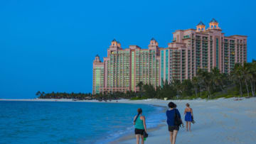 NASSAU, THE BAHAMAS - JUNE 15: Women are walking barefoot on the beach of Paradise Island to the buildings of Atlantis Hotel while sunset on June 15, 2012 in Nassau, The Bahamas. (Photo by EyesWideOpen/Getty Images)