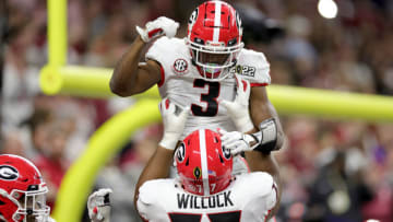 INDIANAPOLIS, INDIANA - JANUARY 10: Zamir White #3 of the Georgia Bulldogs celebrates his touchdown with teammate Devin Willock #77 during the third quarter against the Alabama Crimson Tide in the 2022 CFP National Championship Game at Lucas Oil Stadium on January 10, 2022 in Indianapolis, Indiana. (Photo by Carmen Mandato/Getty Images)