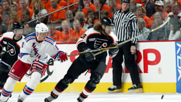 Michal Handzus (#26) of the Philidelphia Flyers attempts to keep the puck from Marcel Hossa (#81) of the New York Rangers (Photo by Len Redkoles/Getty Images)