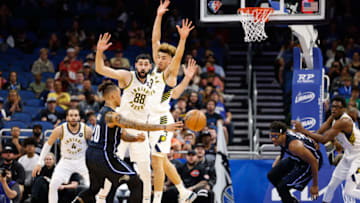 Feb 28, 2022; Orlando, Florida, USA; Orlando Magic guard Markelle Fultz (20) passes the ball past Indiana Pacers guard Chris Duarte (3) in the first quarter at Amway Center. Mandatory Credit: Nathan Ray Seebeck-USA TODAY Sports