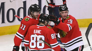Dec 23, 2022; Chicago, Illinois, USA; Chicago Blackhawks center Jonathan Toews (19) celebrates with Chicago Blackhawks right wing Patrick Kane (88) and Chicago Blackhawks right wing Taylor Raddysh (11) after Toews scores against the Columbus Blue Jackets during the third period at the United Center. Mandatory Credit: Matt Marton-USA TODAY Sports