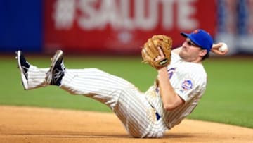 Jul 5, 2014; New York, NY, USA; New York Mets second baseman Daniel Murphy (28) dives for a ground ball by Texas Rangers second baseman Rougned Odor (not pictured) and throws him out at first during the sixth inning of a game at Citi Field. Mandatory Credit: Brad Penner-USA TODAY Sports