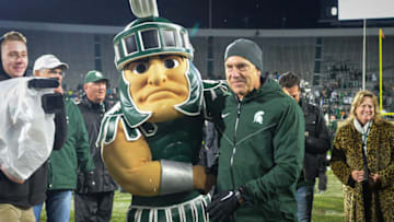 EAST LANSING, MI - NOVEMBER 04: Michigan State Spartans head coach Mark Dantonio is congratulated by Sparty following a Big Ten conference college football game between Michigan State and Penn State on November 4, 2017, at Spartan Stadium in East Lansing, MI.(Photo by Adam Ruff/Icon Sportswire via Getty Images)