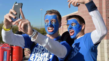 Dec 19, 2015; Las Vegas, NV, USA; Brigham Young Cougars fans Spencer McMillan (left) and Joseph McMillan pose for a selfie with blue face paint before the Las Vegas Bowl against the Utah Utes at Sam Boyd Stadium. Mandatory Credit: Kirby Lee-USA TODAY Sports