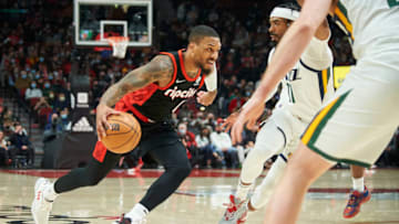 Dec 29, 2021; Portland, Oregon, USA; Portland Trail Blazers guard Damian Lillard (0) drives to the basket against Utah Jazz guard Mike Conley (11) during the first half at Moda Center. Mandatory Credit: Troy Wayrynen-USA TODAY Sports