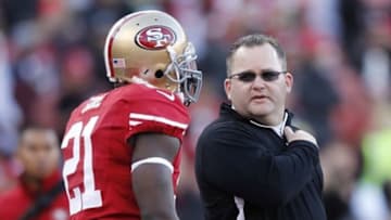 Jan 12, 2013; San Francisco, CA, USA; San Francisco 49ers offensive coordinator Greg Roman (right) talks to running back Frank Gore (21) before the NFC divisional round playoff game against the Green Bay Packers at Candlestick Park. Mandatory Credit: Cary Edmondson-USA TODAY Sports