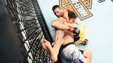 CHICAGO, ILLINOIS - JUNE 09: (R-L) Charles Oliveira of Brazil submits Clay Guida in their lightweight fight during the UFC 225 event at the United Center on June 9, 2018 in Chicago, Illinois. This submission ties the all-time UFC record held by Royce Gracie with 10 submissions. (Photo by Josh Hedges/Zuffa LLC/Zuffa LLC via Getty Images)