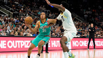 Mar 29, 2023; San Antonio, Texas, USA; San Antonio Spurs guard Romeo Langford (35) drives to the basket against Utah Jazz center Damian Jones (15) during the second half at AT&T Center. Mandatory Credit: Scott Wachter-USA TODAY Sports