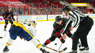 Mar 11, 2021; Raleigh, North Carolina, USA; Carolina Hurricanes forward Morgan Geekie (67) and Nashville Predators center Ryan Johansen (92) take the face off at PNC Arena. Mandatory Credit: James Guillory-USA TODAY Sports