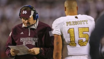 Nov 29, 2014; Oxford, MS, USA; Mississippi State Bulldogs head coach Dan Mullen (L) talks to Mississippi State Bulldogs quarterback Dak Prescott (15) against the Mississippi Rebels at Vaught-Hemingway Stadium. The Rebels won 31-17. Mandatory Credit: Spruce Derden-USA TODAY Sports