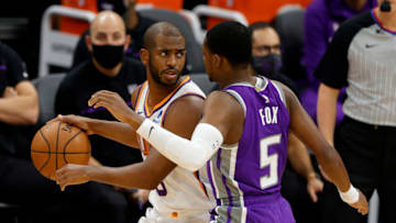 SACRAMENTO, CALIFORNIA - DECEMBER 27: Chris Paul #3 of the Phoenix Suns is guarded by De'Aaron Fox #5 of the Sacramento Kings at Golden 1 Center on December 27, 2020 in Sacramento, California. NOTE TO USER: User expressly acknowledges and agrees that, by downloading and or using this photograph, User is consenting to the terms and conditions of the Getty Images License Agreement. (Photo by Ezra Shaw/Getty Images)
