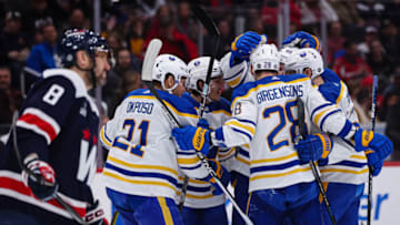 WASHINGTON, DC - MARCH 15: Ilya Lyubushkin #46 of the Buffalo Sabres celebrates with teammates after scoring a goal as Alex Ovechkin #8 of the Washington Capitals looks on during the first period of the game at Capital One Arena on March 15, 2023 in Washington, DC. (Photo by Scott Taetsch/Getty Images)