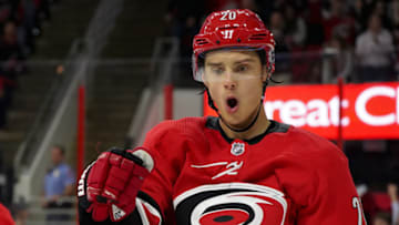 RALEIGH, NC - OCTOBER 09: Carolina Hurricanes Center Sebastian Aho (20) celebrates a goal during a game between the Vancouver Canucks and the Carolina Hurricanes at the PNC Arena in Raleigh, NC on October 9, 2018. Carolina defeated Vancouver 5 - 3. (Photo by Greg Thompson/Icon Sportswire via Getty Images)