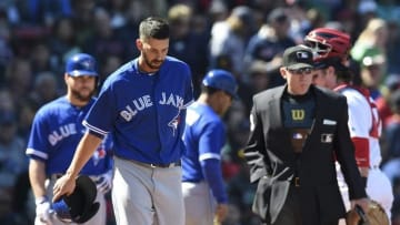 Apr 17, 2016; Boston, MA, USA; Toronto Blue Jays first baseman Chris Colabello (15) walks to first base after getting hit in the head by a pitch during the fourth inning at Fenway Park. Mandatory Credit: Bob DeChiara-USA TODAY Sports