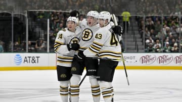 Nov 6, 2023; Dallas, Texas, USA; Boston Bruins defenseman Ian Mitchell (14) and defenseman Mason Lohrei (6) and left wing Danton Heinen (43) celebrates a goal scored by Lohrei against the Dallas Stars during the first period at the American Airlines Center. Mandatory Credit: Jerome Miron-USA TODAY Sports