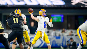 CHARLOTTE, NORTH CAROLINA - DECEMBER 04: Kenny Pickett #8 of the Pittsburgh Panthers attempts a pass against the Wake Forest defense during the second half of the ACC Championship game at Bank of America Stadium on December 04, 2021 in Charlotte, North Carolina. (Photo by Logan Whitton/Getty Images)