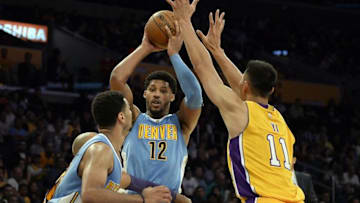 Oct 7, 2016; Los Angeles, CA, USA; Los Angeles Lakers forward Yi Jianlian (11) defends against Denver Nuggets forward Jarnell Stokes (12) during the second half at Staples Center. Mandatory Credit: Richard Mackson-USA TODAY Sports