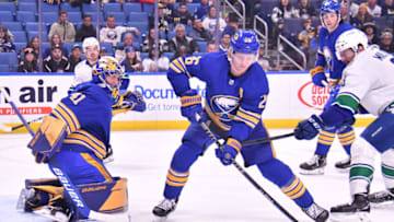 Nov 15, 2022; Buffalo, New York, USA; Buffalo Sabres defenseman Rasmus Dahlin (26) deflects a shot by the Vancouver Canucks as goaltender Craig Anderson (41) looks on in the third period at KeyBank Center. Mandatory Credit: Mark Konezny-USA TODAY Sports